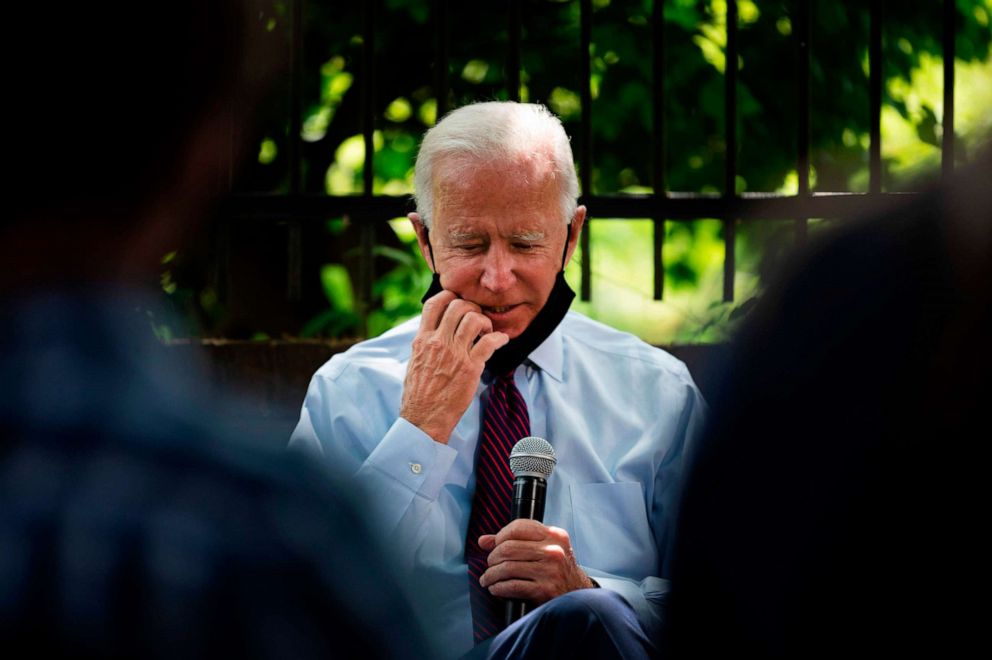 PHOTO: Democratic presidential candidate Joe Biden adjusts his facemask as he meets with Pennsylvania families who have benefited from the Affordable Care Act on June 25, 2020, in Lancaster, Pa.