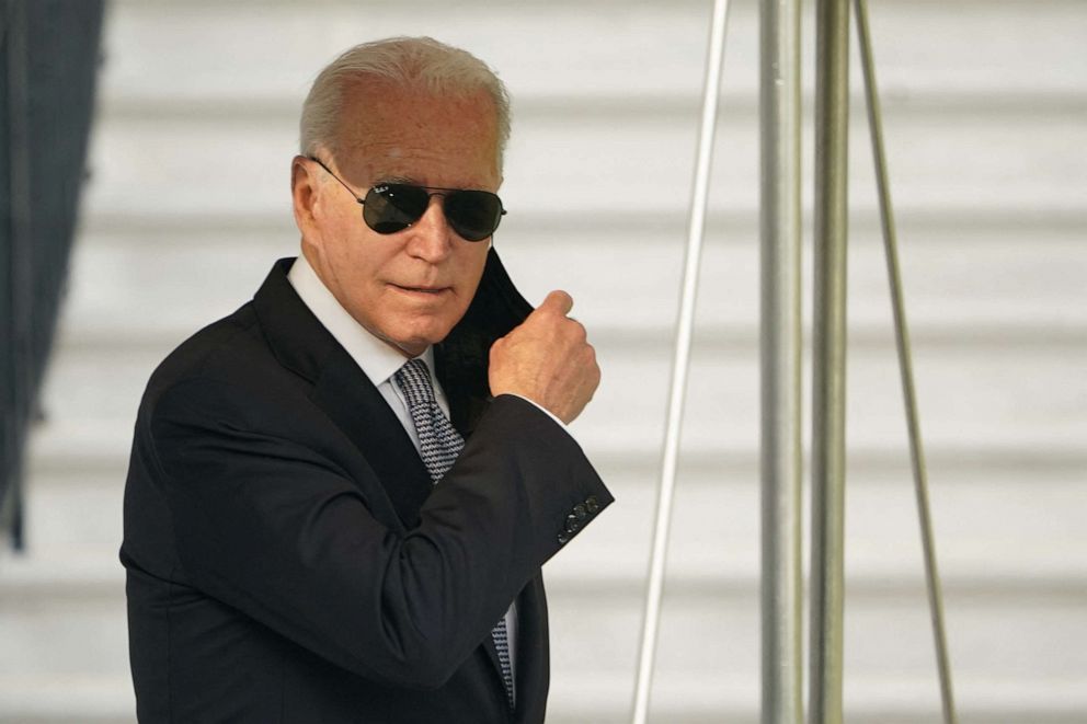 President Joe Biden removes a mask as he leaves the White House to board Marine One in Washington on July 30, 2021.