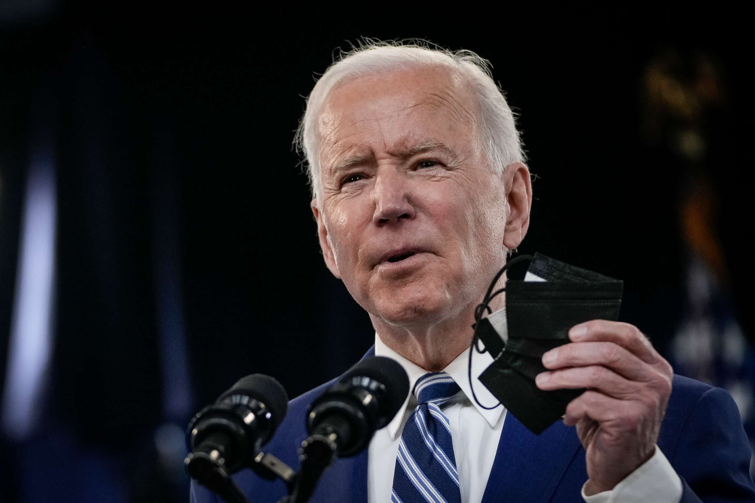 PHOTO: President Joe Biden holds up a face mask as he delivers remarks on the COVID-19 response and the state of vaccinations on March 29, 2021.