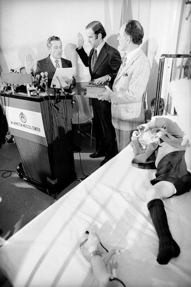 PHOTO: Senator Joseph Biden takes the oath of office from the Senate's secretary, Frank Valeo with his father-in-law Robert Hunter and son Joseph Beau Biden at his side, in Beau's hospital room, Wilmington, Del.,  Jan. 05, 1973.