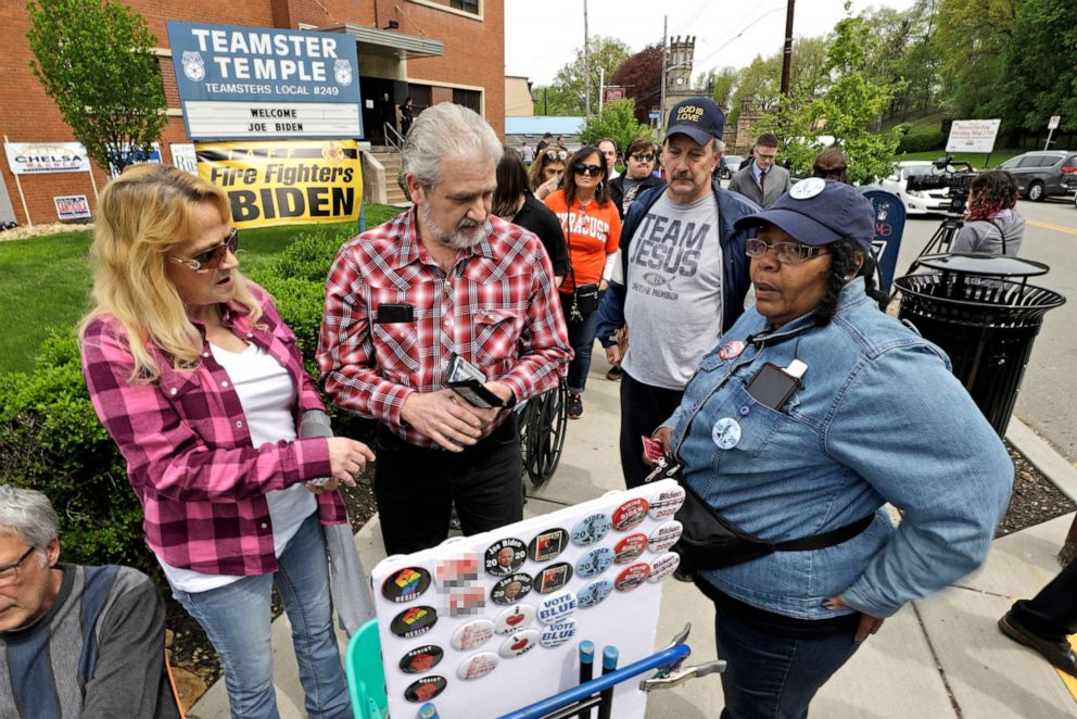 PHOTO: A woman sells buttons outside the Teamster Hall Local 249 before a rally by former Vice President and Democratic presidential candidate Joe Biden at the Teamster Hall Local 249 in Pittsburgh, April 29, 2019.