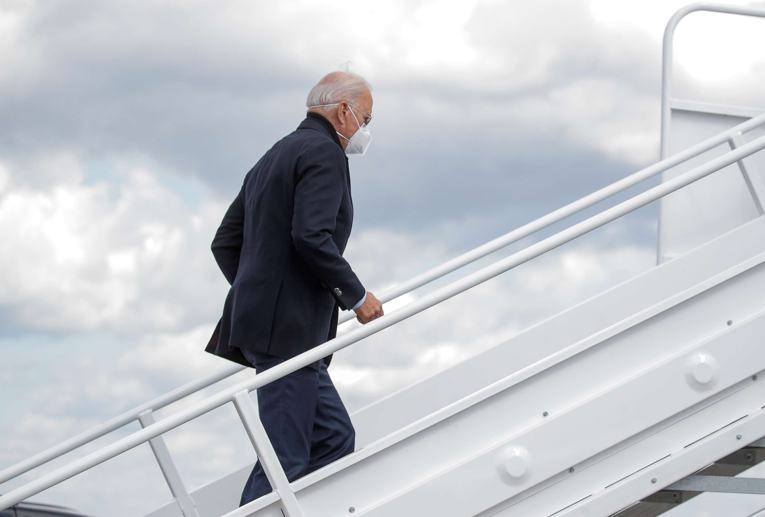 PHOTO: Democratic presidential nominee Joe Biden boards a plane as he departs on campaign travel to Michigan from New Castle Airport in New Castle, Del., Oct. 2, 2020.