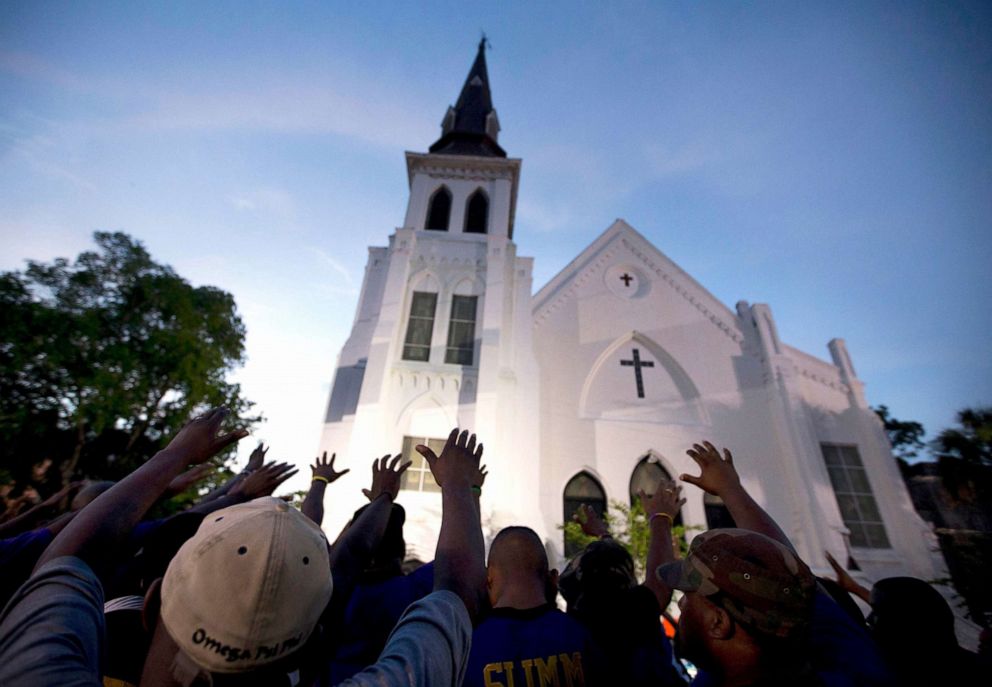 PHOTO: The men of Omega Psi Phi Fraternity Inc. lead a crowd of people in prayer outside the Emanuel AME Church, after a memorial for the nine people killed by Dylann Roof in Charleston, S.C., June 19, 2015.