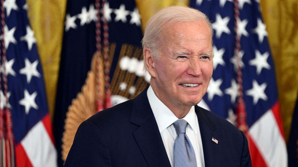 PHOTO: President Joe Biden listens to Vice President Kamala Harris before speaking about lowering healthcare costs, in the East Room of the White House in Washington, DC, Aug. 29, 2023.