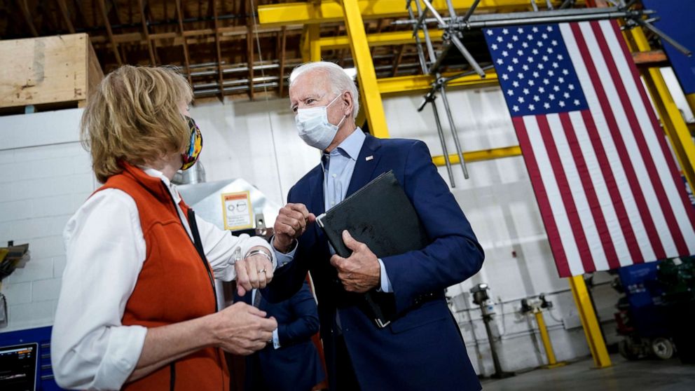 PHOTO: Democratic presidential nominee and former Vice President Joe Biden fist bumps Sen. Tina Smith, D-Minn., after speaking and touring Jerry Alander Carpenter Training Center on Sept. 18, 2020, in Hermantown, Minn.