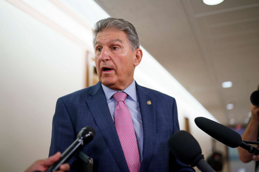 PHOTO: Sen. Joe Manchin talks to reporters as he arrives to chair the Senate Energy and Natural Resources Committee, at the Capitol in Washington. 
