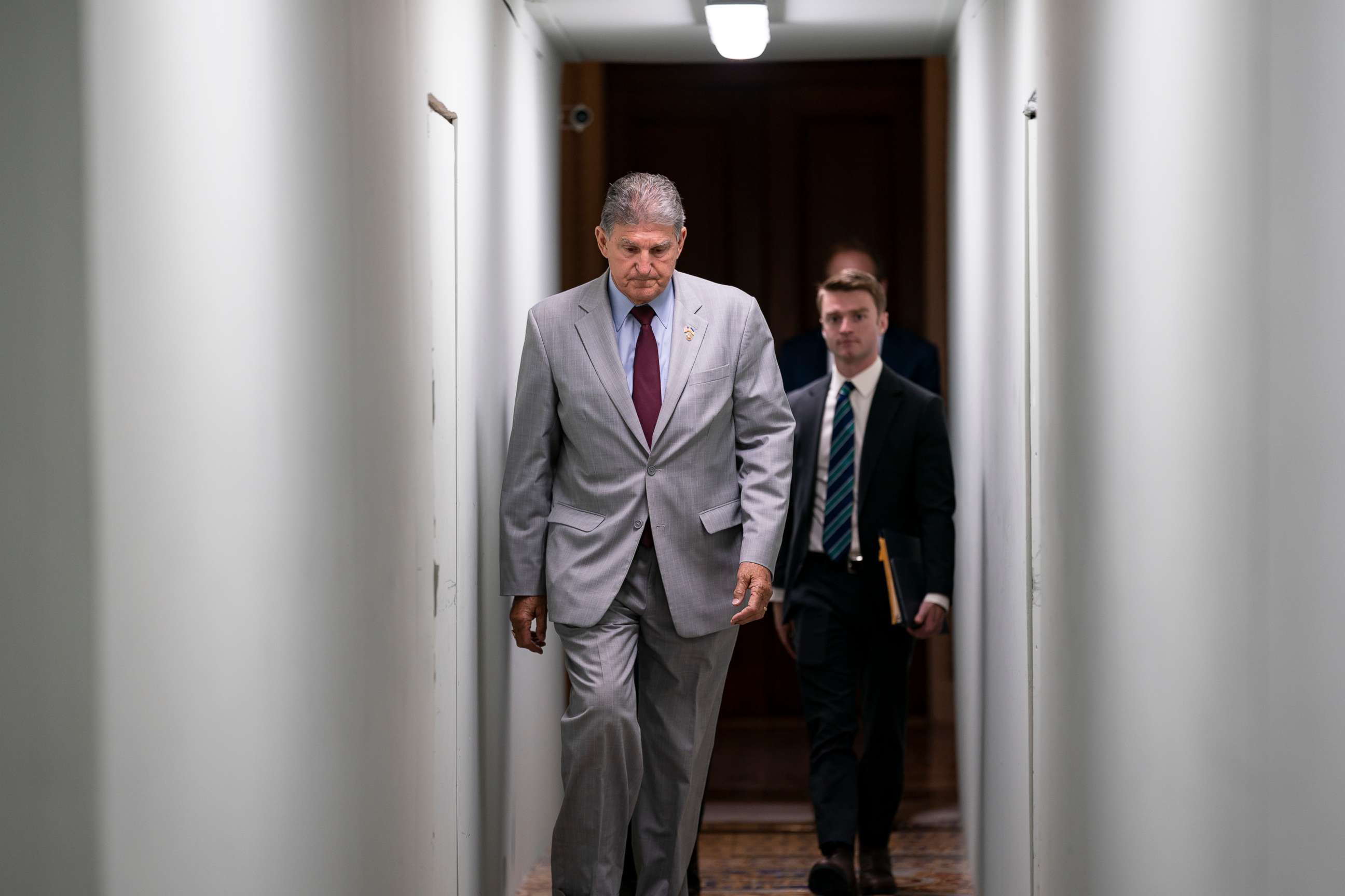 PHOTO: Sen. Joe Manchin crosses through a construction tunnel at the Capitol in Washington, Tuesday, June 14, 2022.