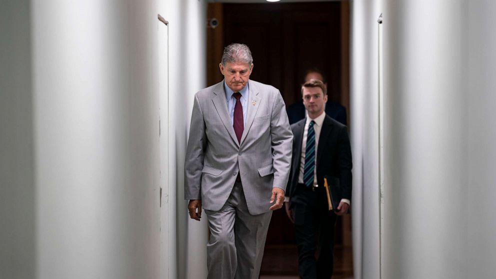 PHOTO: Sen. Joe Manchin crosses through a construction tunnel at the Capitol in Washington, Tuesday, June 14, 2022.
