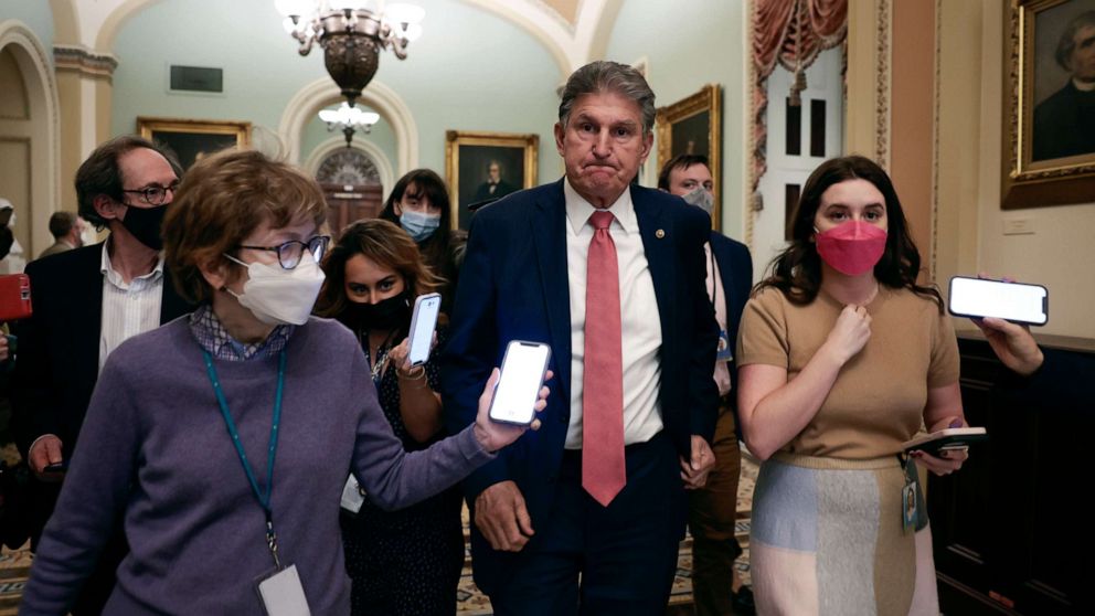 PHOTO: Sen. Joe Manchin is followed by reporters as he leaves a caucus meeting with Senate Democrats at the U.S. Capitol Building, Dec. 17, 2021, in Washington, DC.