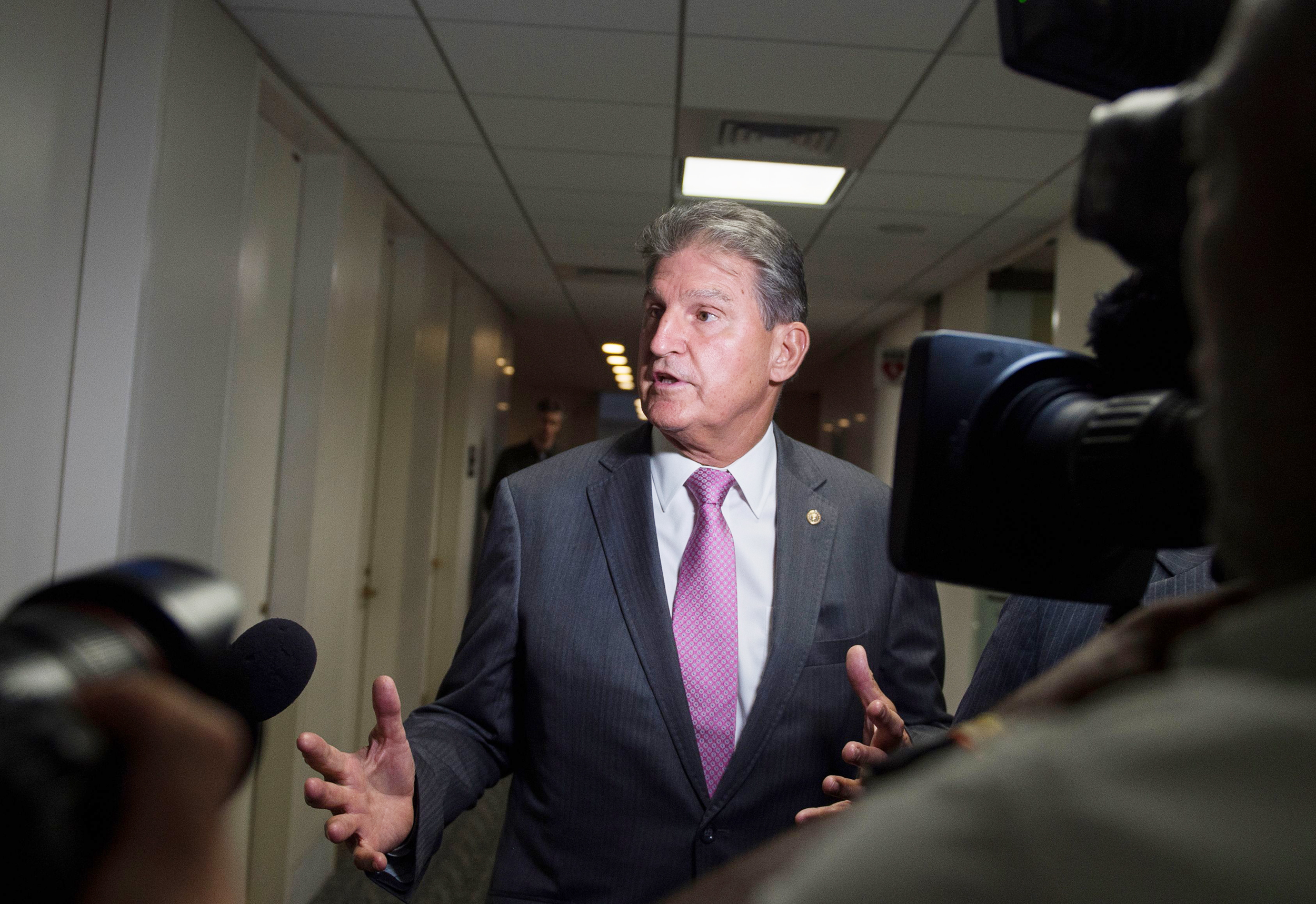 PHOTO: U.S. Senator Joe Manchin speaks with reporters in the Senate Hart building as a rally against Supreme Court nominee Brett Kavanaugh takes place on Capitol Hill in Washington, D.C., Oct. 4, 2018.