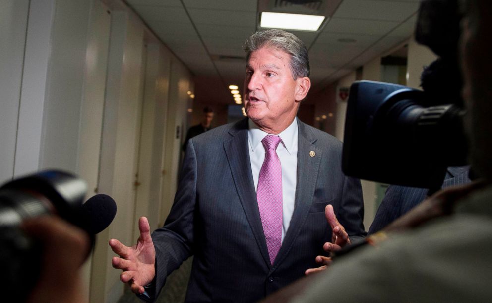 PHOTO: U.S. Senator Joe Manchin speaks with reporters in the Senate Hart building as a rally against Supreme Court nominee Brett Kavanaugh takes place on Capitol Hill in Washington, D.C., Oct. 4, 2018.