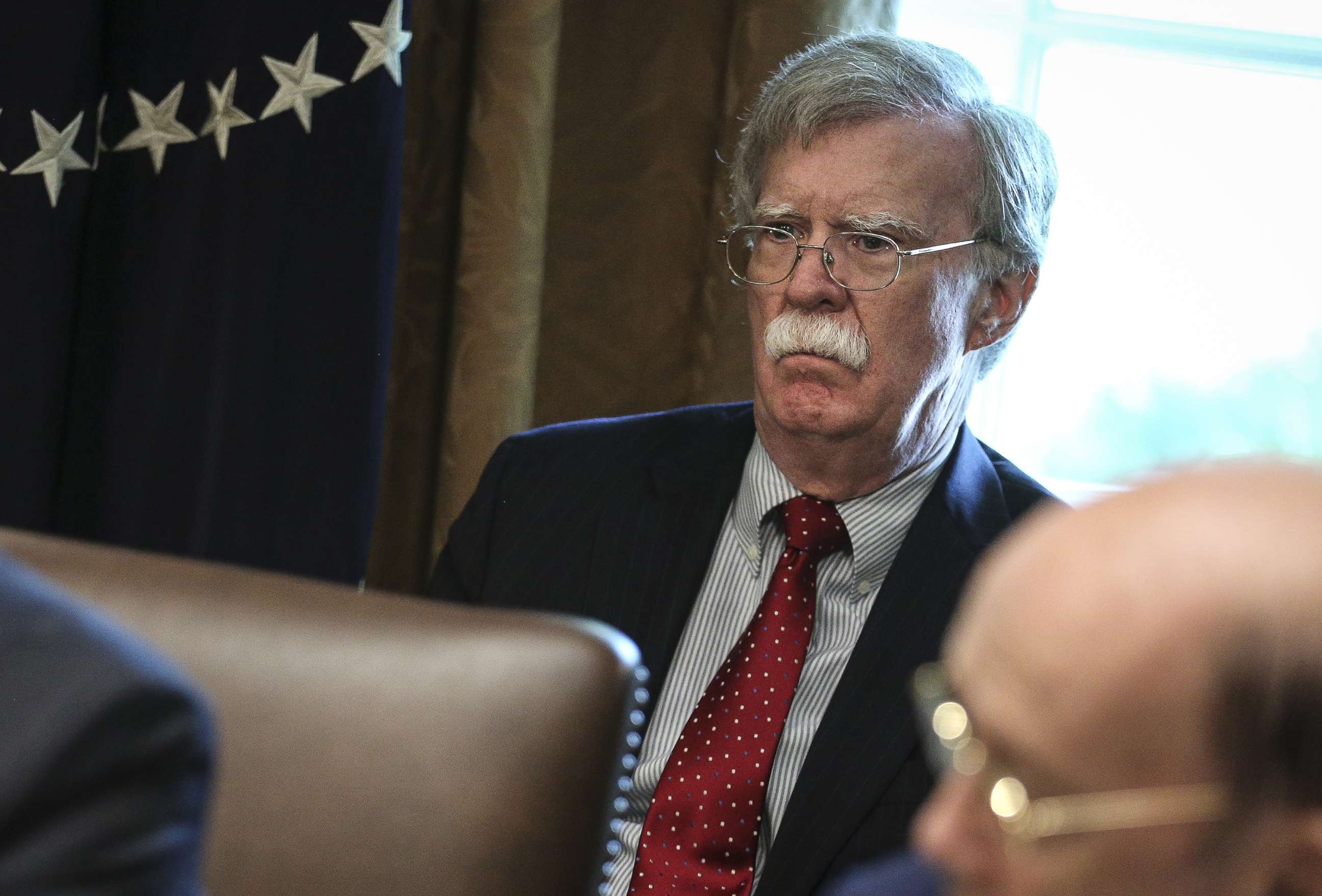 PHOTO: National security adviser John Bolton listens during a meeting with President Donald Trump, not pictured, in the Cabinet Room of the White House in Washington, D.C., Aug. 16, 2018.