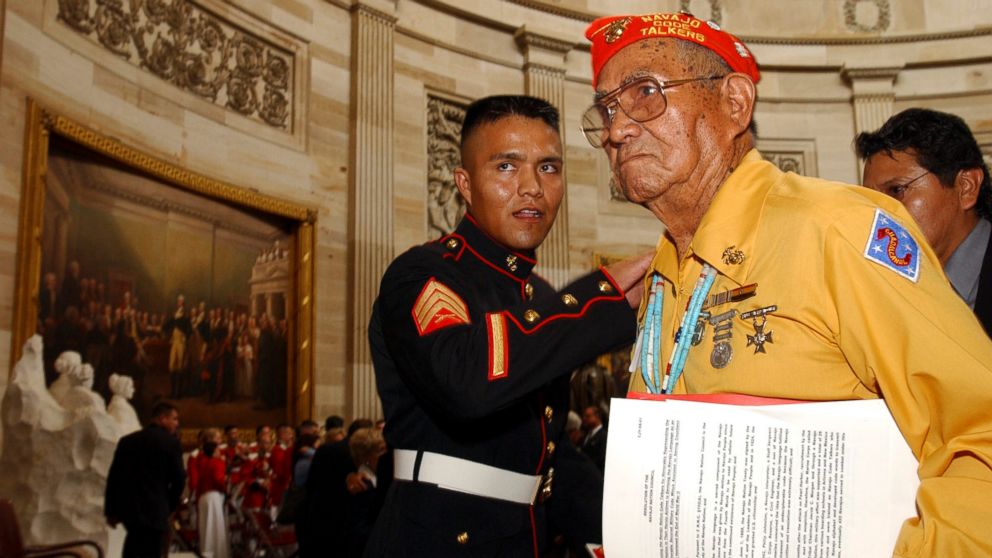 PHOTO: John Brown, Jr., Navajo Code Talker, gets a pat on the back from a young Marine after he received the Congressional Gold Medal at the Capitol in Washington, D.C. 