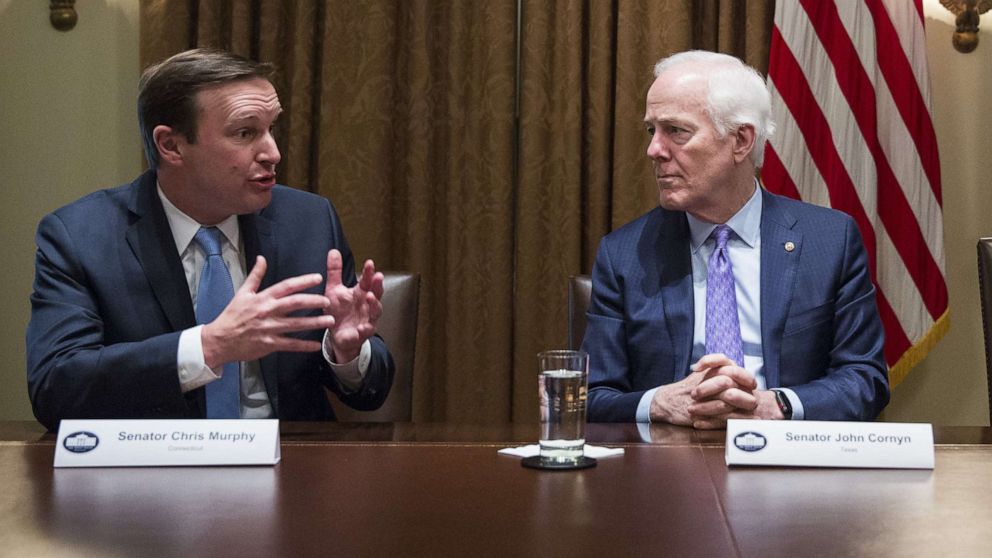 PHOTO: Senator Chris Murphy speaks with Sen. John Cornyn during a meeting in Washington, Feb. 18, 2018.