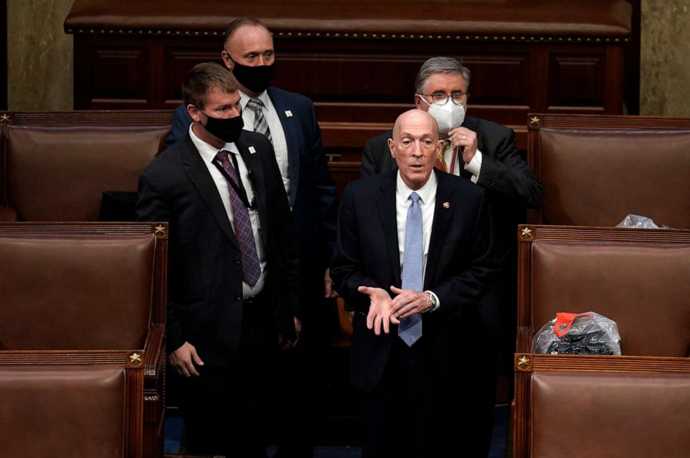 PHOTO: Sergeant at Arms of the U.S. House of Representatives Paul Irving, front right, walks with Capitol Police officers as they begin to secure and clean up the House chamber after protesters stormed the U.S. Capitol in Washington, D.C., Jan. 6, 2021.