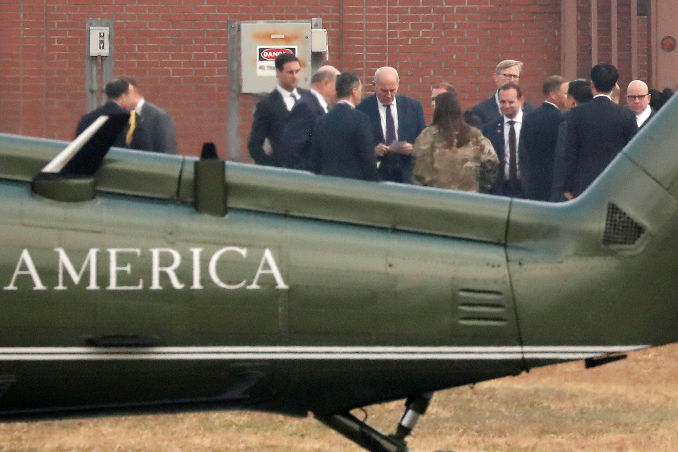 PHOTO: White House Chief of Staff John Kelly looks at notes while huddling with White House senior staff to discuss the situation after being grounded from an attempt to visit the DMZ, at a U.S. military post in Seoul, South Korea, Nov. 8, 2017.