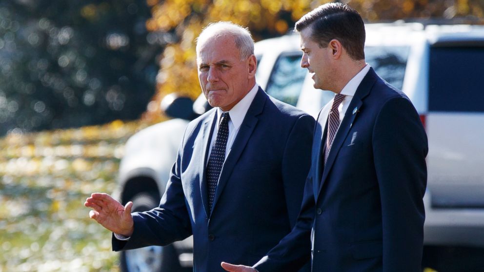 White House Chief of Staff John Kelly walks with White House staff secretary Rob Porter to board Marine One on the South Lawn of the White House in Washington, Nov. 29, 2017.