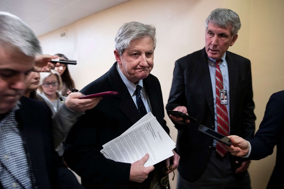 PHOTO: Sen. John Kennedy from Kentucky carries printed copies of news reports regarding Ukraine as he walks to the Senate chamber for a vote on Capitol Hill in Washington, Dec. 2, 2019.