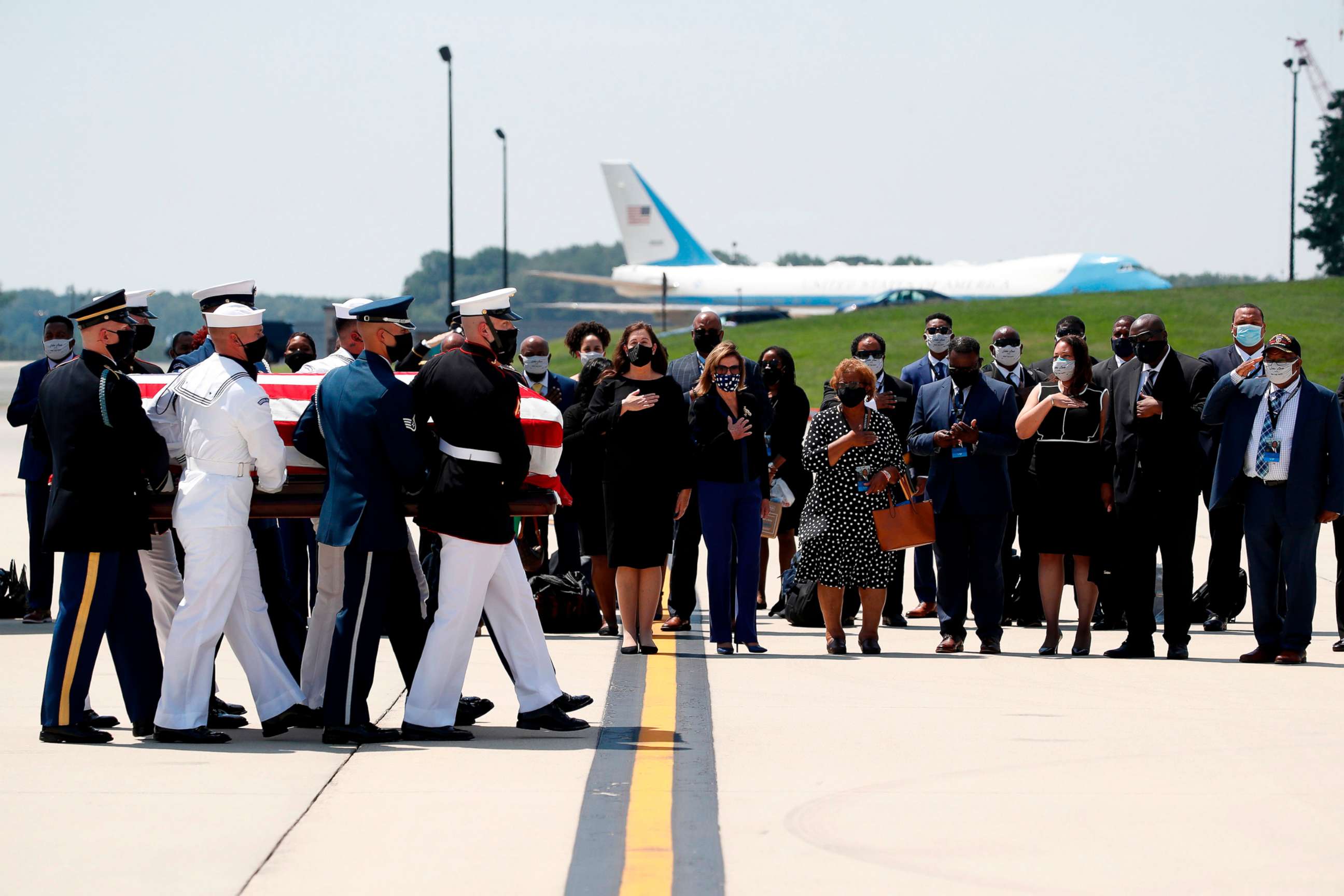 PHOTO: The flag-draped casket of Rep. John Lewis is carried by a joint services military honor guard to the hearse, on July 27, 2020, at Andrews Air Force Base, Md. 