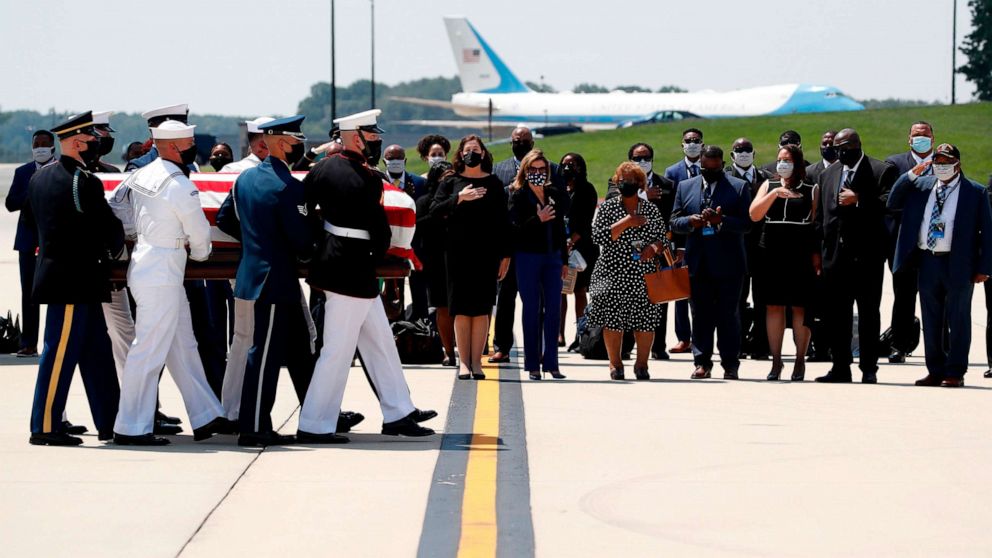 PHOTO: The flag-draped casket of Rep. John Lewis is carried by a joint services military honor guard to the hearse, on July 27, 2020, at Andrews Air Force Base, Md. 