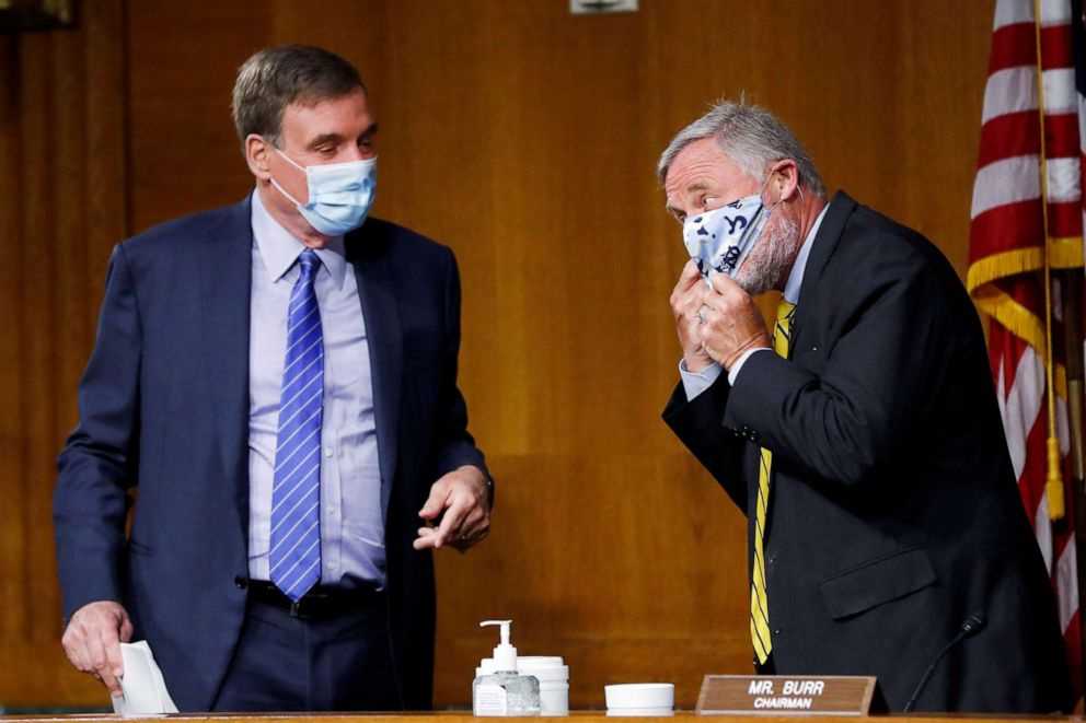 PHOTO: Sen. Richard Burr adjusts his mask while talking with Sen. Mark Warner at the conclusion of a Senate Intelligence Committee nomination hearing for Rep. John Ratcliffe, on Capitol Hill in Washington, May 5, 2020.