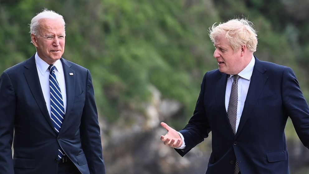 PHOTO: Britain's Prime Minister Boris Johnson speaks with U.S. President Joe Biden while they walk outside Carbis Bay Hotel, Carbis Bay, Cornwall, Britain, June 10, 2021.