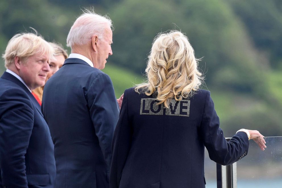 PHOTO: U.S. first lady Jill Biden wears a jacket with the phrase "Love" as she stands next to U.S. President Joe Biden, Britain's Prime Minister Boris Johnson and his wife Carrie Johnson, during their meeting in Cornwall, Britain, June 10, 2021.