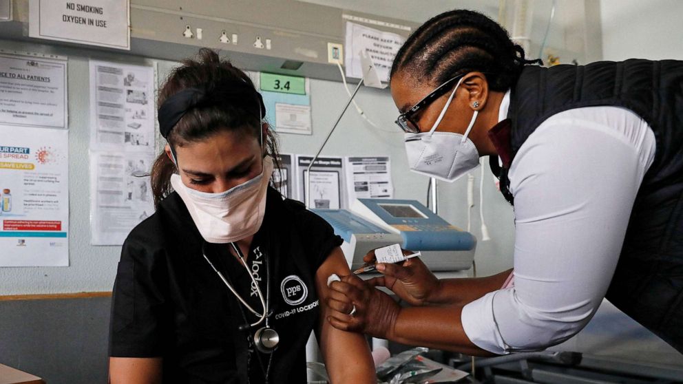 PHOTO: Doctor Anike Baptiste receives a dose of the Johnson & Johnson vaccine against the COVID-19 coronavirus from Mokgadi Malebye, a professional nurse at the Steve Biko Academic Hospital in Pretoria on Feb. 17, 2021.