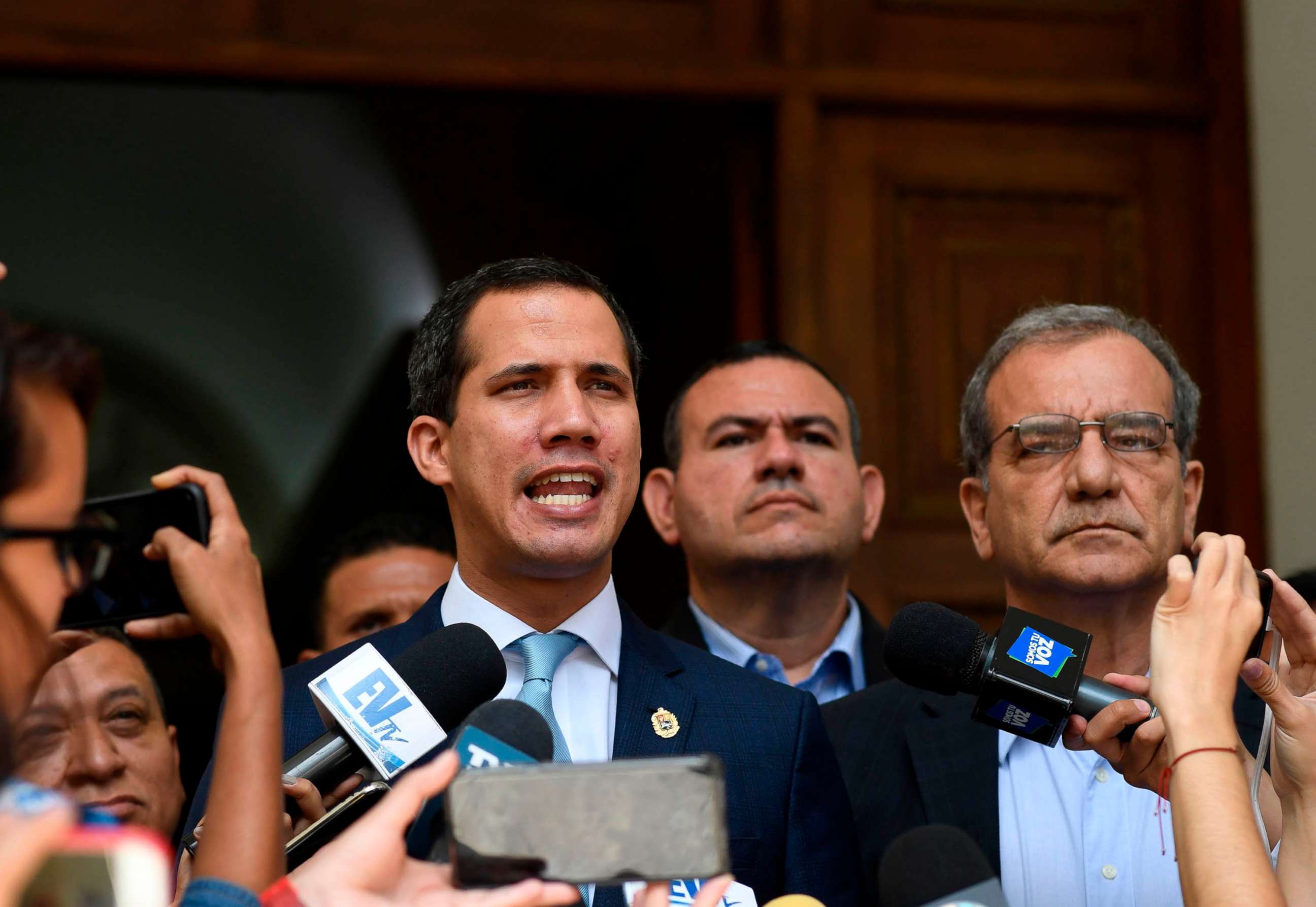 PHOTO: Venezuelan opposition leader and self-proclaimed acting president Juan Guaido (L) speaks to the press before a session at the National Assembly in Caracas on August 6, 2019.