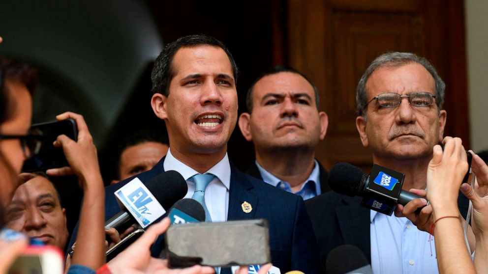 PHOTO: Venezuelan opposition leader and self-proclaimed acting president Juan Guaido (L) speaks to the press before a session at the National Assembly in Caracas on August 6, 2019.