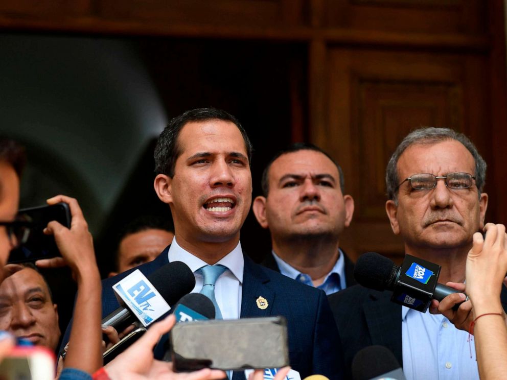 PHOTO: Venezuelan opposition leader and self-proclaimed acting president Juan Guaido (L) speaks to the press before a session at the National Assembly in Caracas on August 6, 2019.