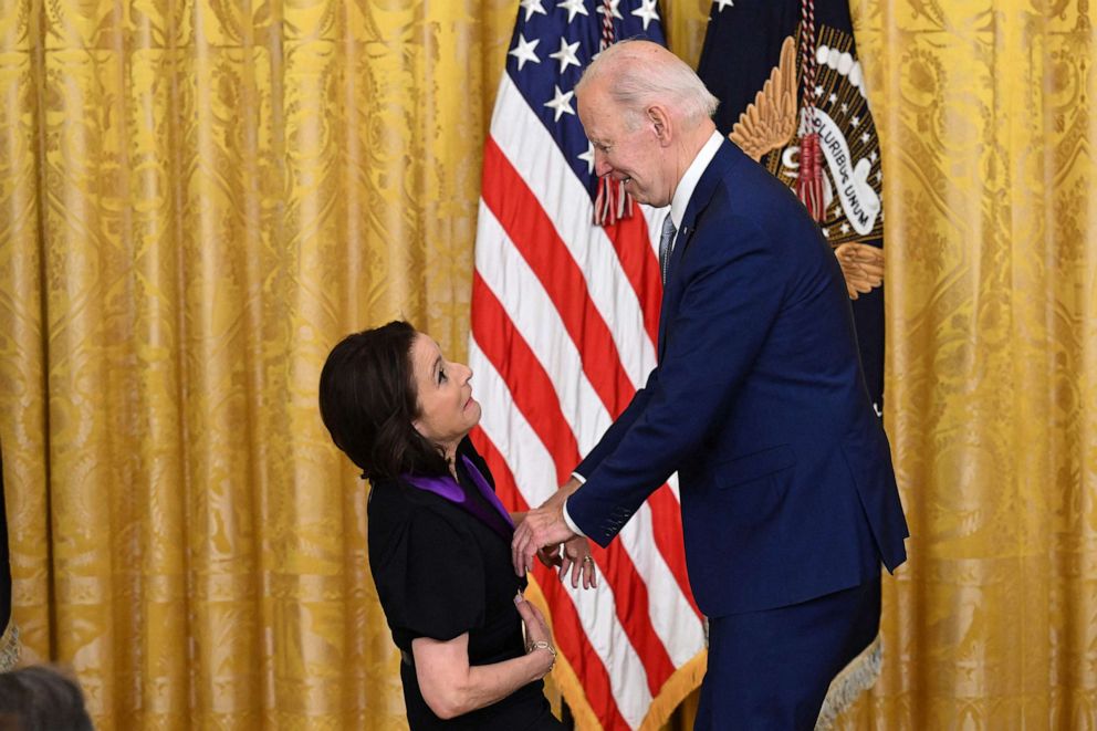 PHOTO: Actress Julia Louis-Dreyfus jokes with President Joe Biden as he presents her with the 2021 National Medal of Arts during a ceremony in the East Room of the White House in Washington, DC, on March 21, 2023.