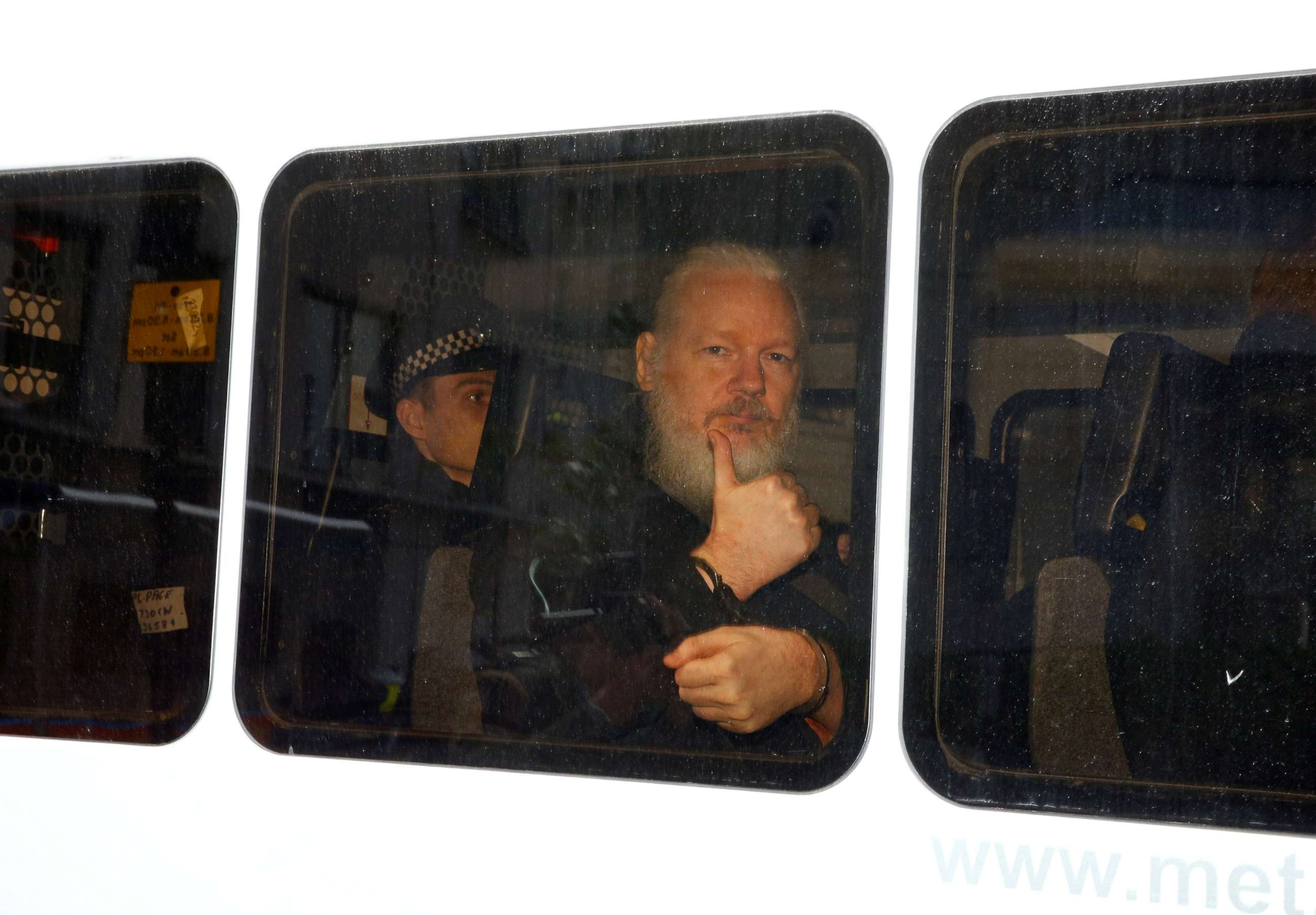 PHOTO: WikiLeaks founder Julian Assange is seen in a police van after was arrested by British police outside the Ecuadorian embassy in London, April 11, 2019.