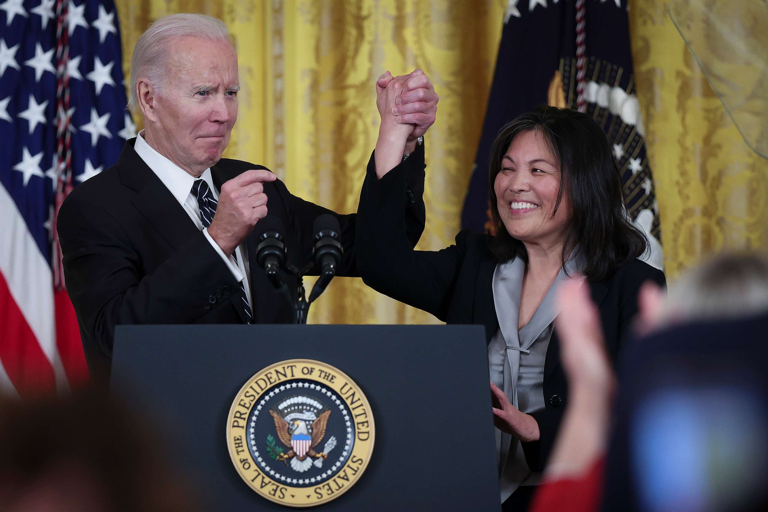PHOTO: U.S. President Joe Biden links arms with Julie Su, his nominee to be the next Secretary of Labor during an event in the East Room of the White House, March 1, 2023, in Washington.