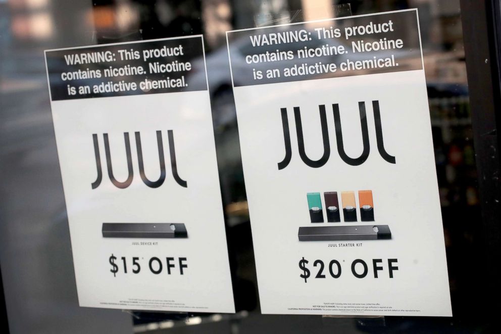 PHOTO: Signs in the window of the Smoke Depot advertise electronic cigarettes and pods by Juul, the nation's largest maker of e-cigarette products, Sept. 13, 2018, in Chicago.