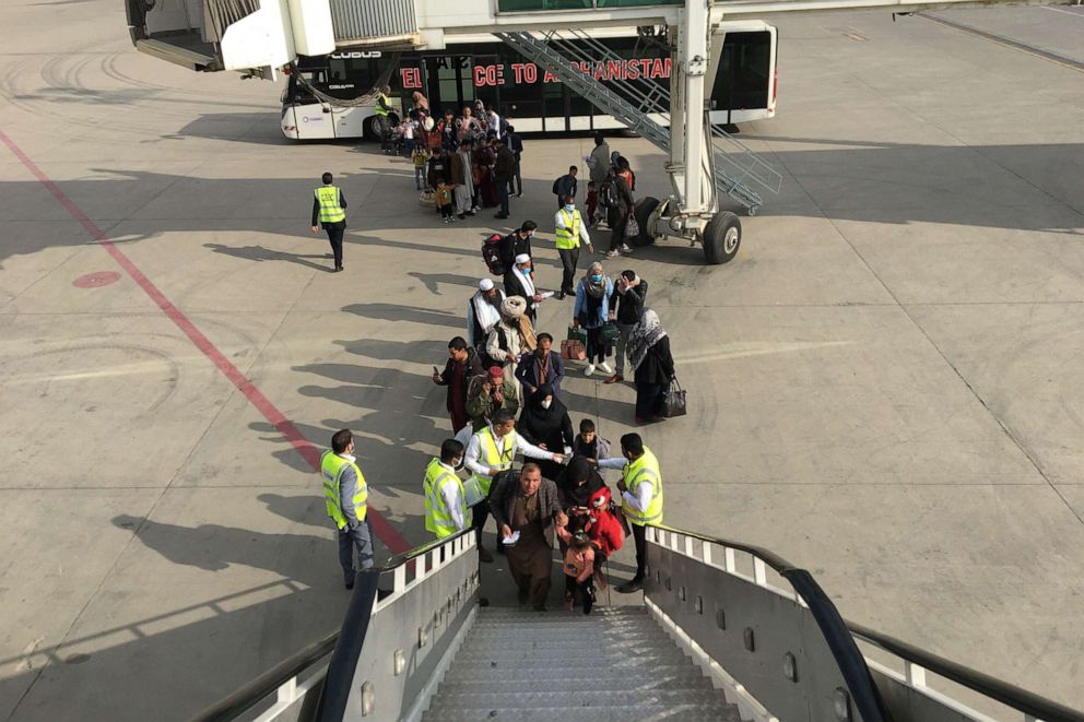 PHOTO: Passengers board a Qatar Air aircraft bound to Doha at Kabul airport on Nov. 4, 2021.