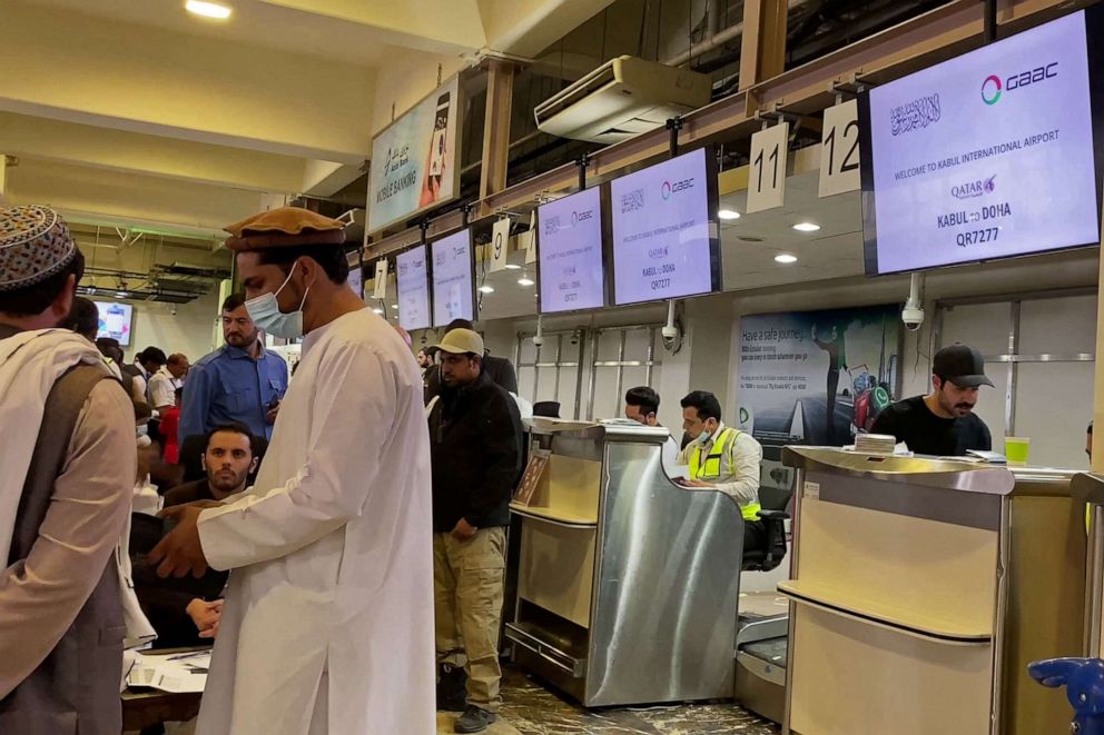 PHOTO: This video frame grab taken from AFPTV footage shows passengers and ground staff standing in front of a counter of Qatar Airways flight to Doha at the airport in Kabul on Oct. 20, 2021.