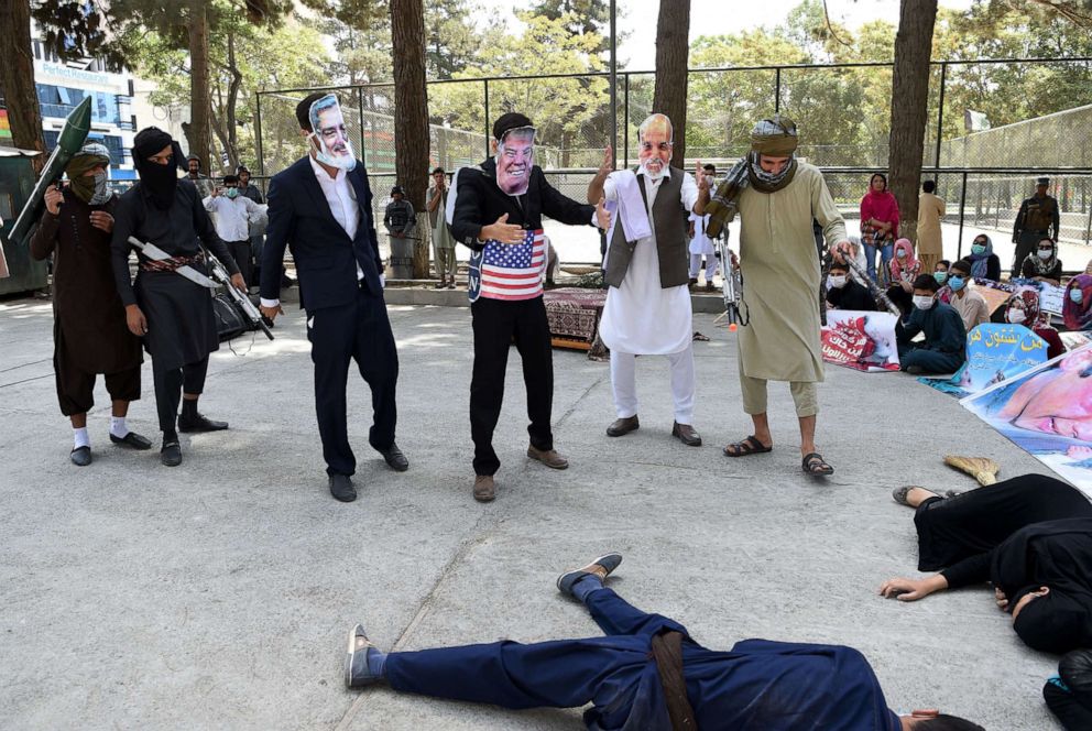 PHOTO: In this Aug. 11, 2017, file photo, protesters wear masks of Afghan Chief Executive Abdullah Abdullah (L) and US President Trump (C) and Afghan President Ashraf Ghani (2R) to protest against the Afghan government and Taliban militants, in Kabul.