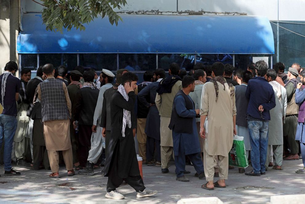 PHOTO: Afghans wait in long lines for hours to try to withdraw money in front of Kabul Bank, in Kabul, Afghanistan, Aug. 15, 2021.