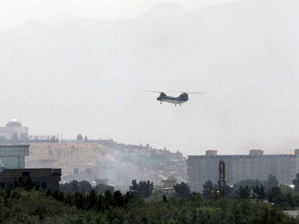 PHOTO: CH-46 Sea Knight military transport helicopter flies over Kabul, Afghanistan Aug. 15, 2021.