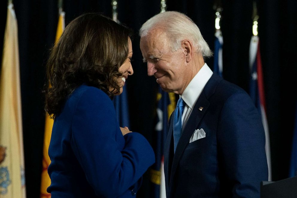 PHOTO: Democratic presidential candidate Joe Biden and his running mate Sen. Kamala Harris pass each other at a campaign event in Wilmington, Del., Aug. 2, 2020. 