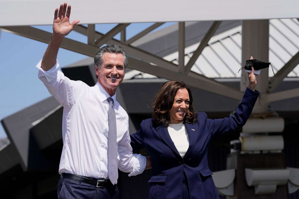 PHOTO: California Gov. Gavin Newsom and Vice President Kamala Harris wave during a campaign event at the IBEW-NECA Joint Apprenticeship Training Center in San Leandro, Calif., Sept. 8, 2021.