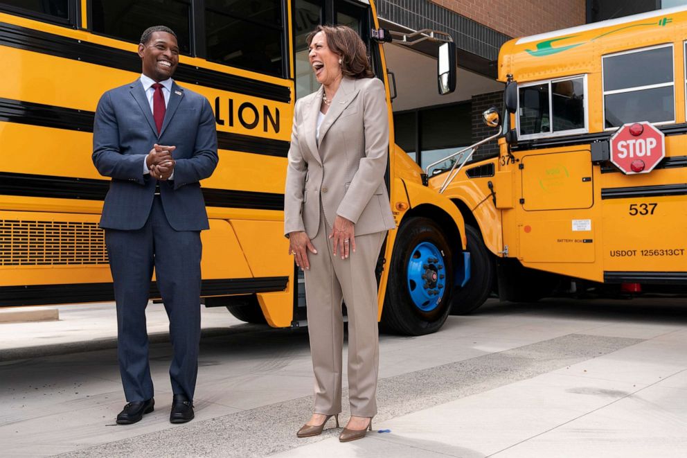 PHOTO: In this May 20, 2022, file photo, Vice President Kamala Harris laughs with Environmental Protection Agency Administrator Michael Regan, during a tour of electric school buses at Meridian High School in Falls Church, Va.