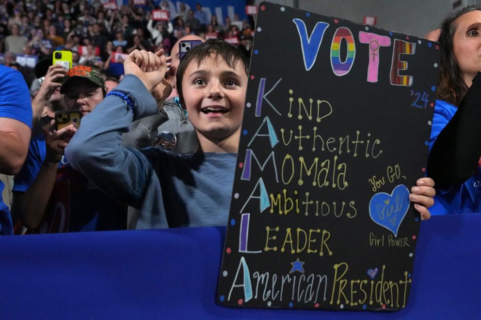 PHOTO: A young supporter holds a sign as Democratic presidential nominee Vice President Kamala Harris speaks during a campaign rally in Memorial Hall at Muhlenberg College in Allentown, Pa., Nov. 4, 2024.