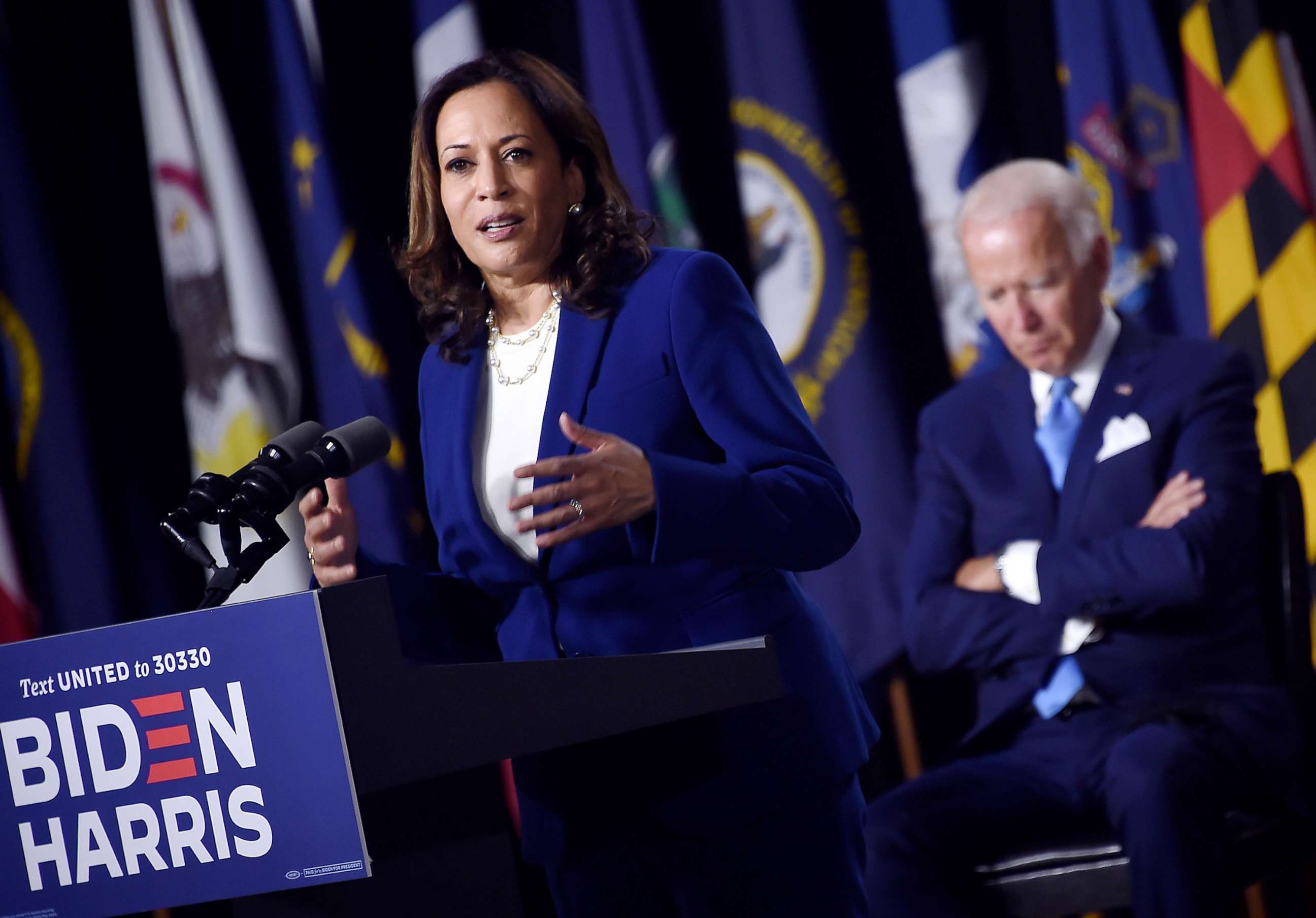 PHOTO: Democratic presidential nominee and former Vice President Joe Biden listen to his vice presidential running mate, Senator Kamala Harris, speak during their first press conference together in Wilmington, Del., Aug. 12, 2020.