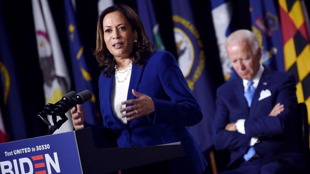PHOTO: Democratic presidential nominee and former Vice President Joe Biden listen to his vice presidential running mate, Senator Kamala Harris, speak during their first press conference together in Wilmington, Del., Aug. 12, 2020.