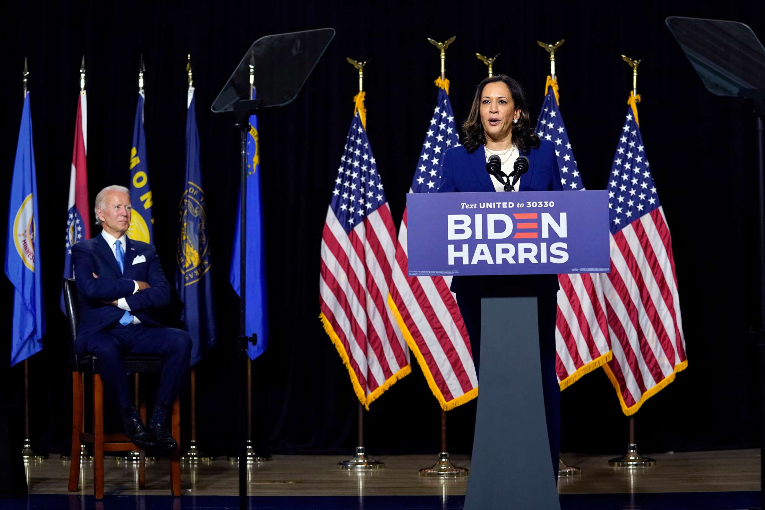 PHOTO: Democratic presidential candidate former Vice President Joe Biden listens as his running mate Sen. Kamala Harris speaks during a campaign event at Alexis Dupont High School in Wilmington, Del., Aug. 12, 2020.
