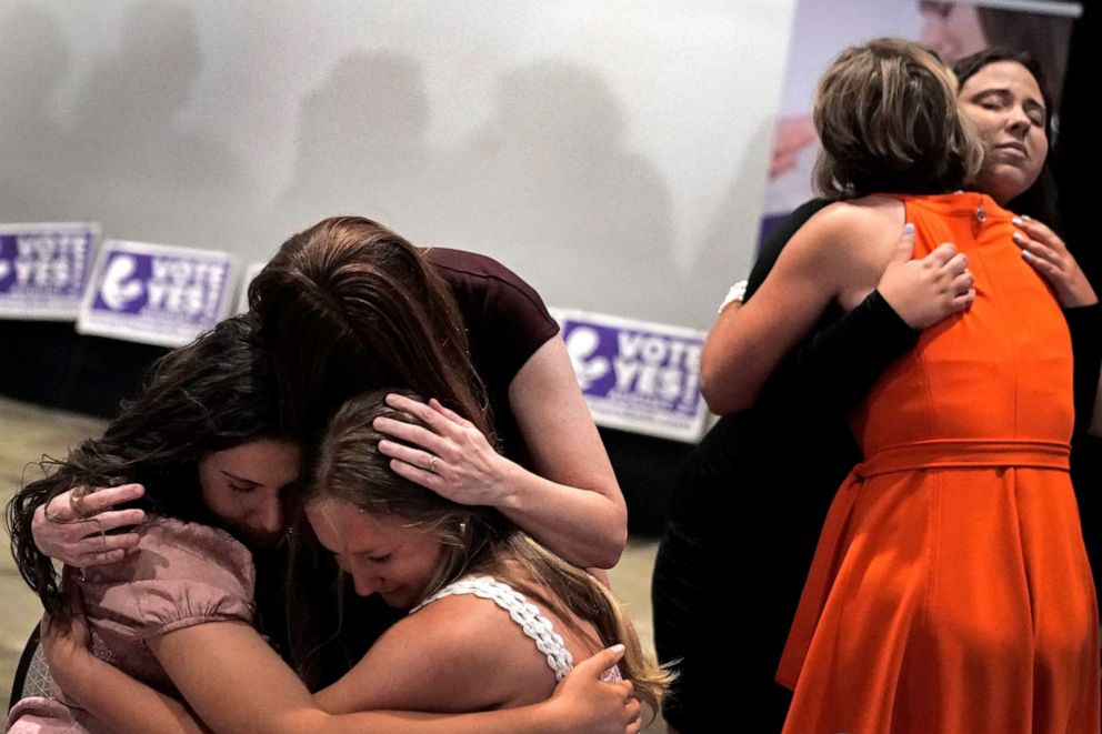 PHOTO: People hug during a Value Them Both watch party after a ballot initiative involving a constitutional amendment removing abortion protections from the Kansas constitution failed, Aug. 2, 2022, in Overland Park, Kan.