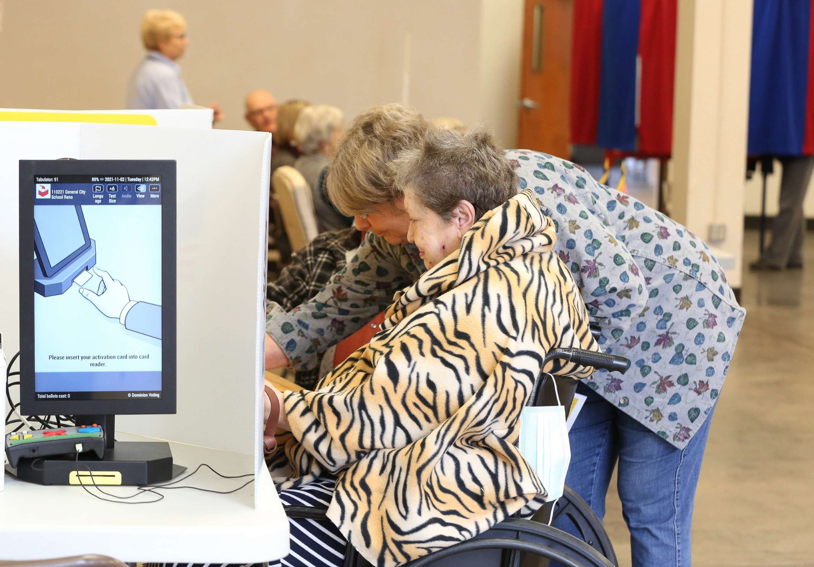 PHOTO: Election worker Rebecca Crockford helps Betty Greever with her provisional ballot at the Encampment Building on the Kansas State Fairgrounds, Nov. 2, 2021.