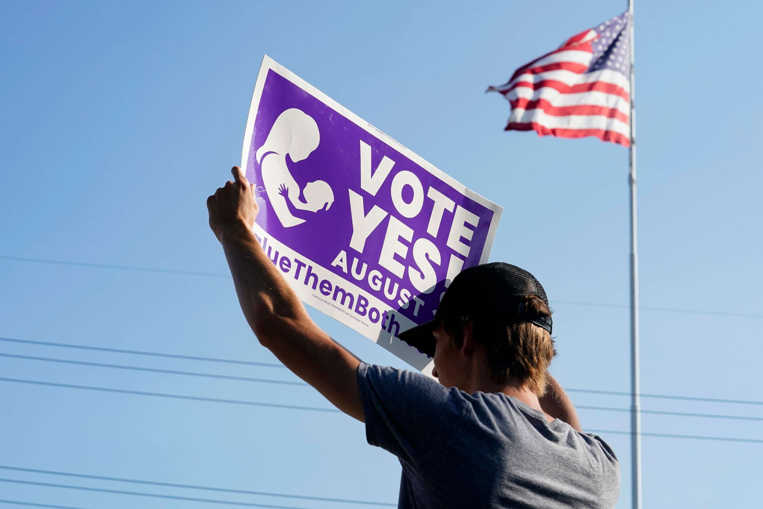 PHOTO: A supporter of the Vote Yes to a Constitutional Amendment on Abortion holds up a sign in Olathe, Kansas, Aug. 01, 2022. 